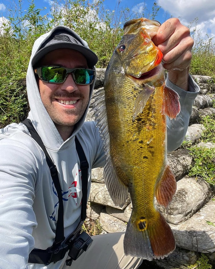 Angler holding a peacock bass